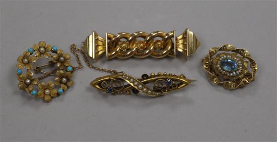 A late Victorian 15ct gold, sapphire and seed pearl bar brooch, a 10ct gold gem set brooch and two other yellow metal brooches.